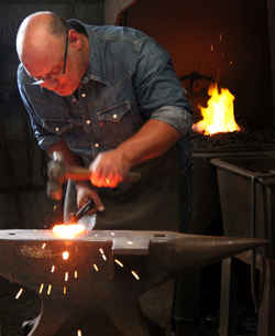 Matthew Galpin works a meteorite on his anvil.