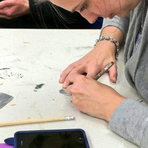 A member of staff making a votive for Ex Voto artwork.