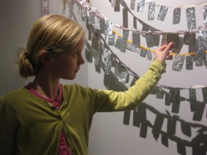 Visitor adding their artwork to Ex Voto.