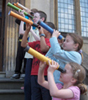 Children look through telescopes they have made in the 'Galileo's Telescope' workshop.